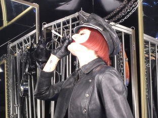 Mistress Tokyo Smoking Cigarette In Leather, Gloves And Muir Cap